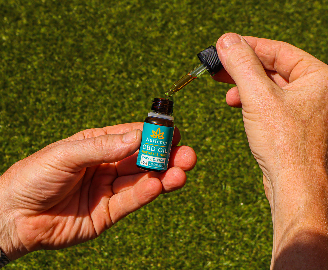 Man holding cold pressed cbd oil