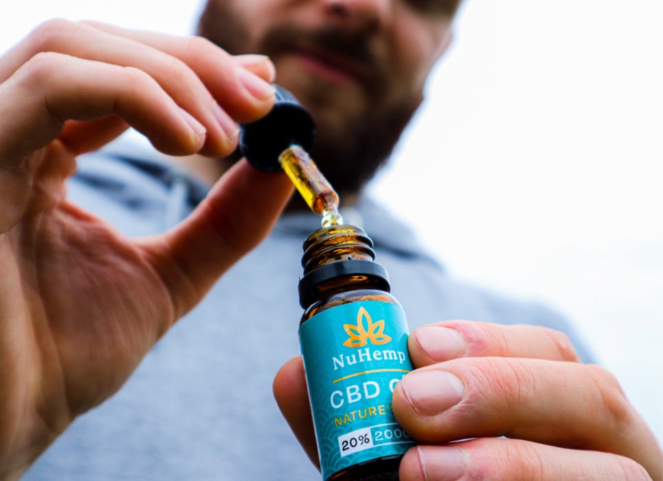 man holding 2000mg CBD oil bottle