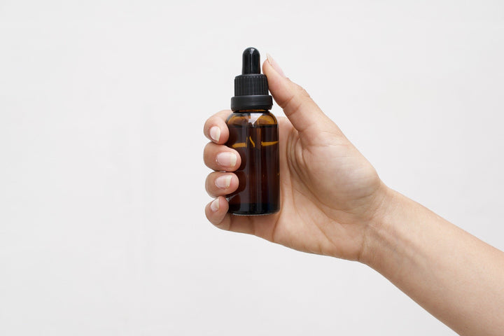 holding cbd oil bottle