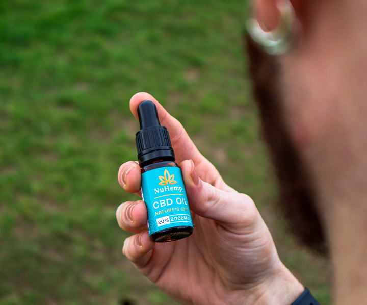 man looking at 2000mg cbd oil bottle